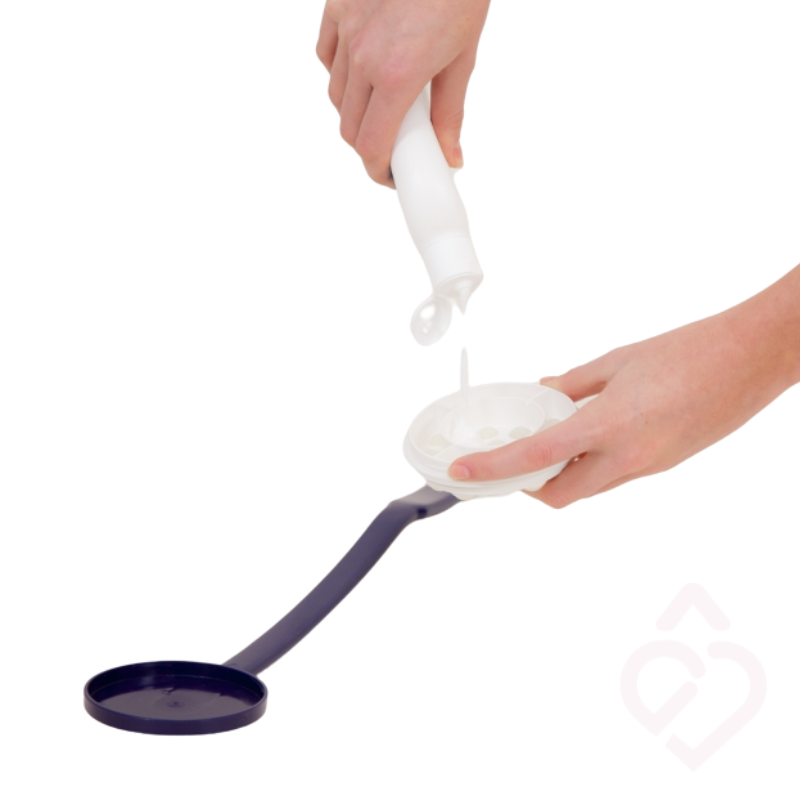Colocação de creme na cabeça do aplicador, preparando-o para distribuir o produto em zonas do corpo de difícil alcance.