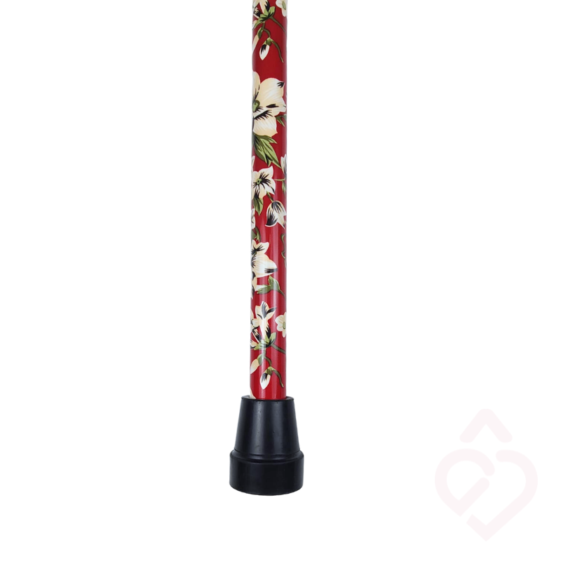 Haste vermelha com padrão de flores brancas e ponteira preta da bengala.