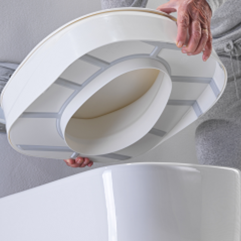 Parte inferior do elevador de sanita ergonómico, mostrando o sistema de encaixe que permite uma colocação simples e estável sobre a sanita, proporcionando maior segurança durante a utilização.